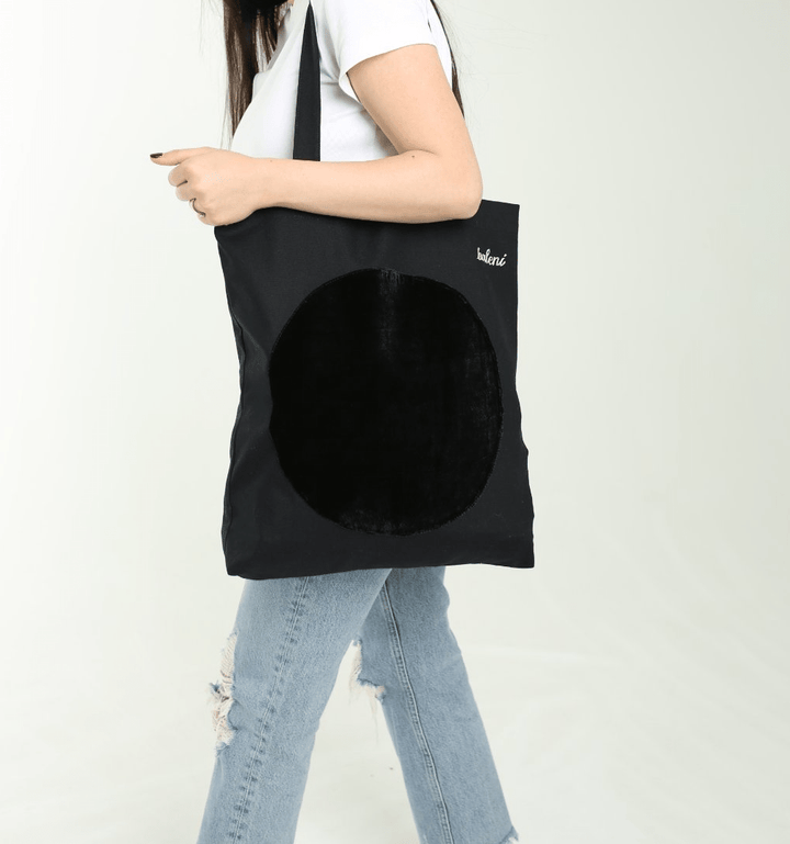 Black canvas tote bag with velvet patch
