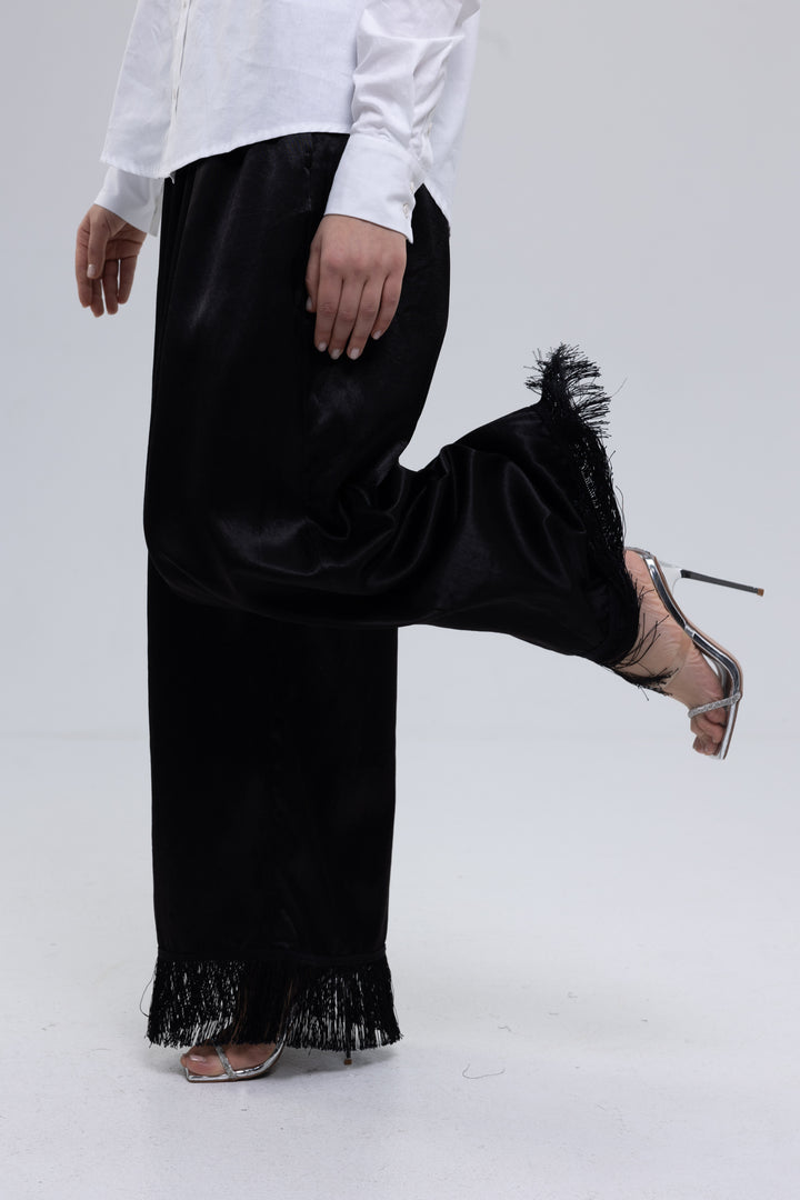 Black satin wide-leg pants with fringed hem