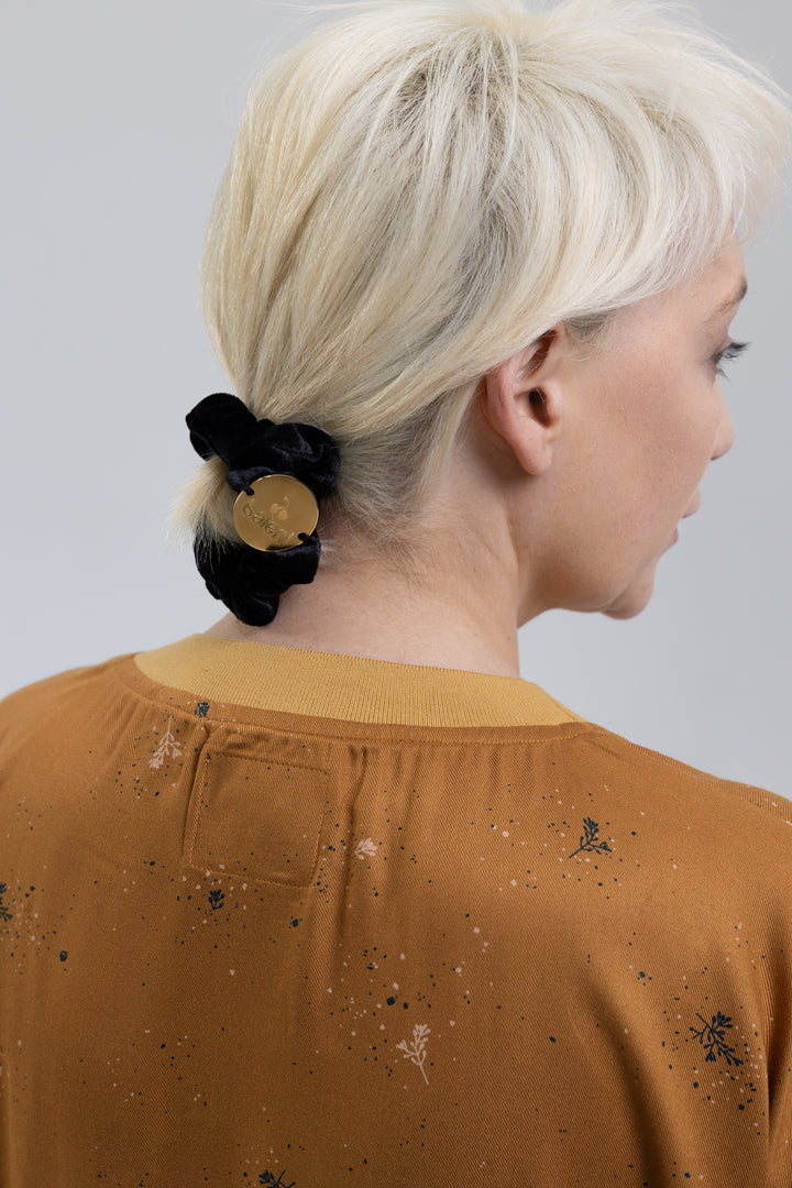 Black silk scrunchie worn in hair