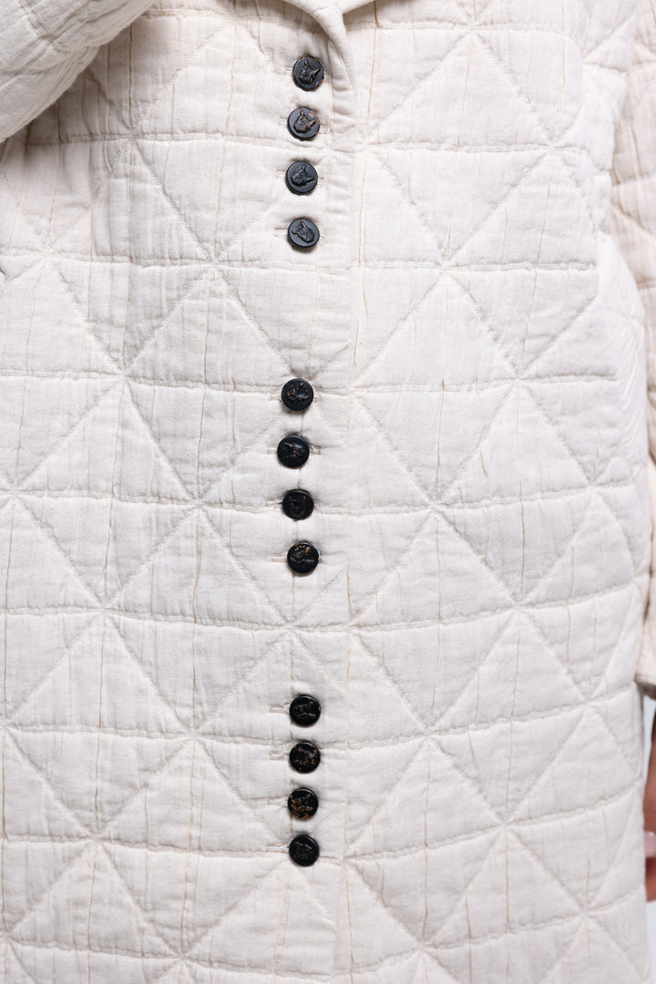 Cream quilted coat with black embossed leather buttons and logo patch - Baleni