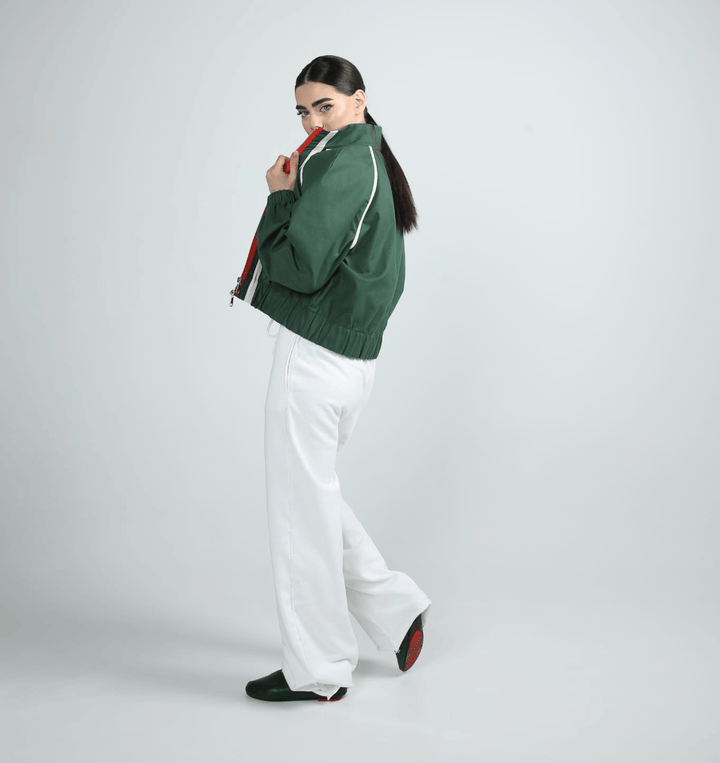 Side view of a green cotton bomber jacket for women with stripe sleeves and elasticated hem - Baleni