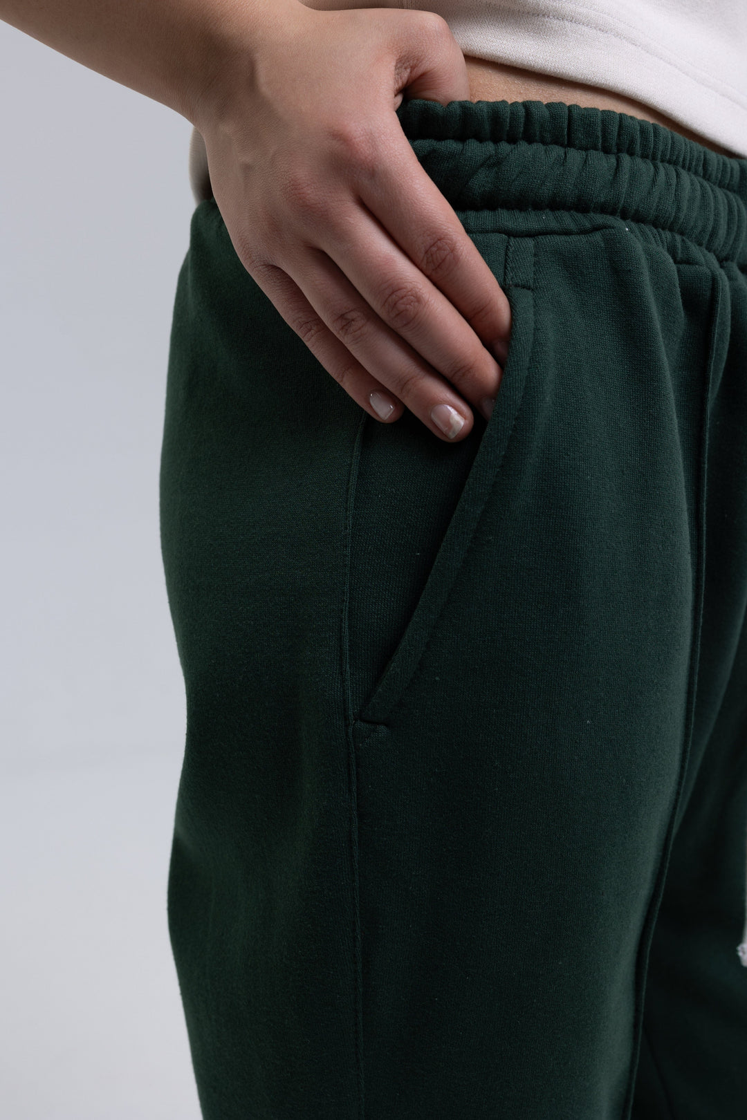 Green flared sweatpants with front pintuck