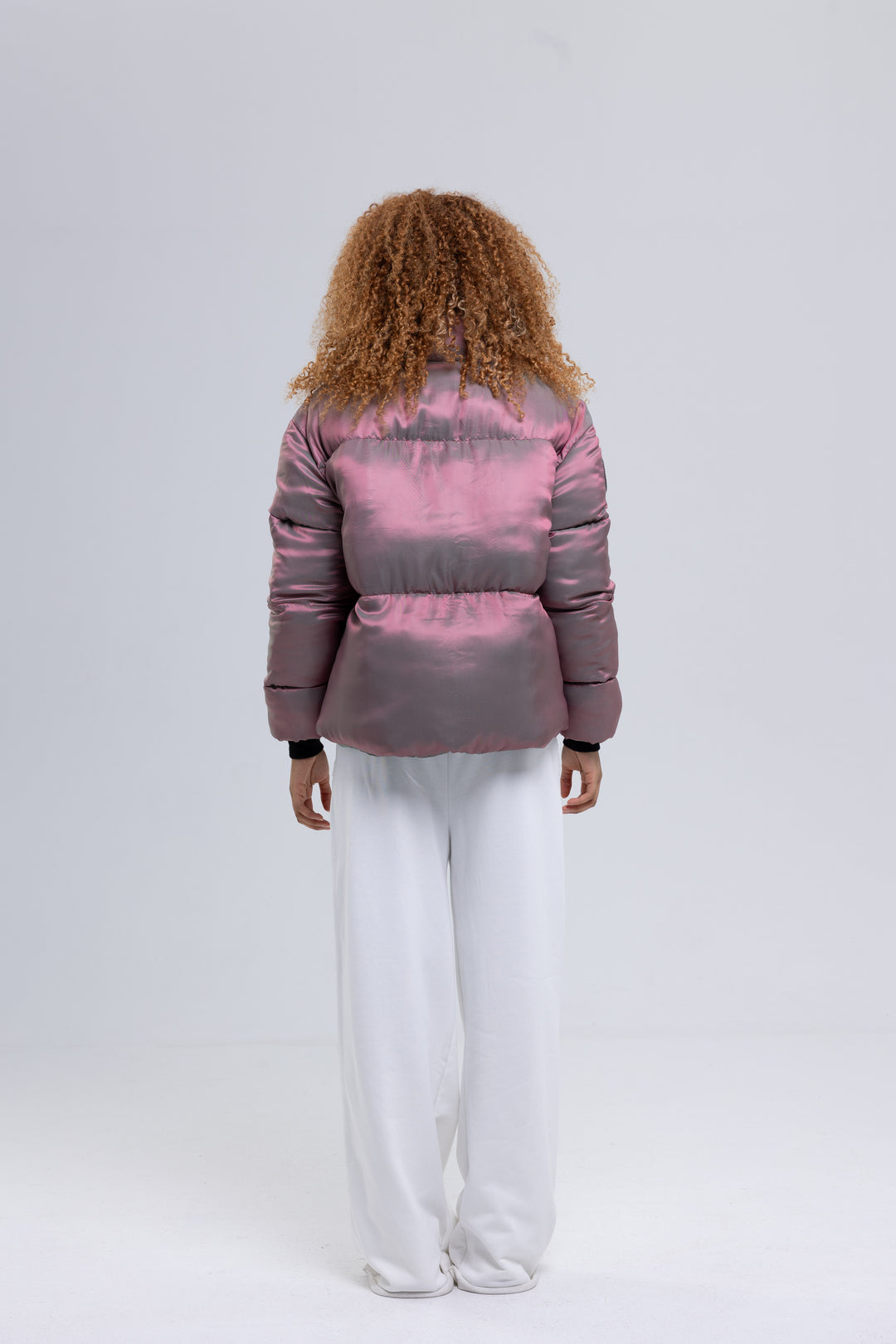 Back view of a pink quilted puffer jacket with horizontal channels - Baleni