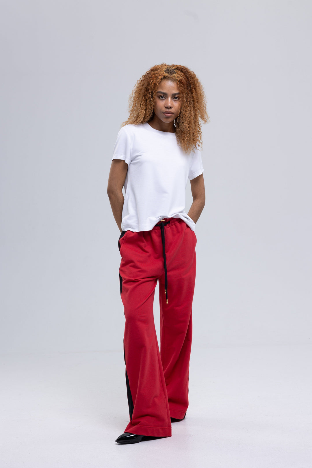 Pinkish red wide-leg sweatpants with black side stripe