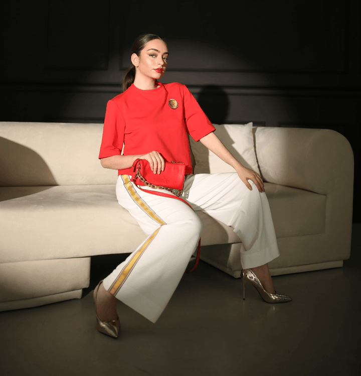 White wide-leg pants with golden ribbon side stripe